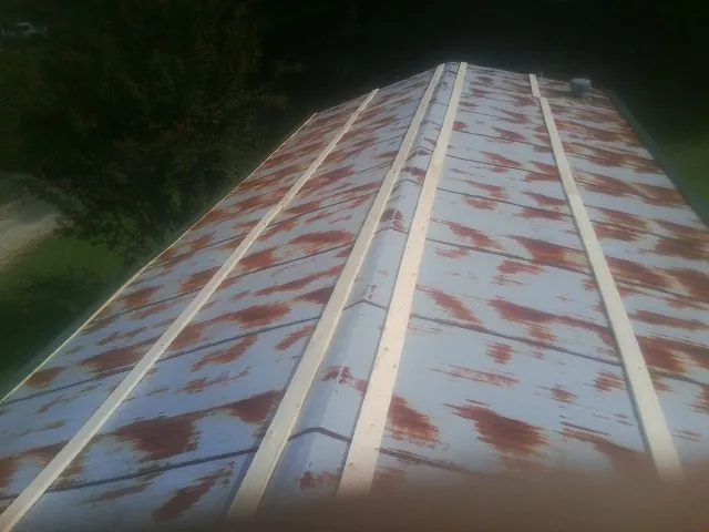 Rusted metal roof panels with new wood purlins before replacement — Storm Damage Roof Repair in Hallieford by Roofing Brothers