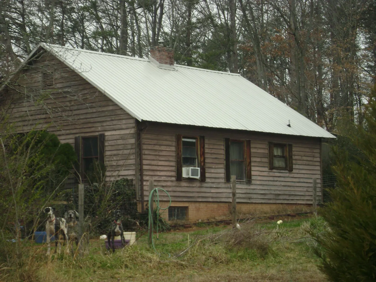 White metal roof on an old wood sided farmhouse, from a Metal Roof Installation job in Hallieford